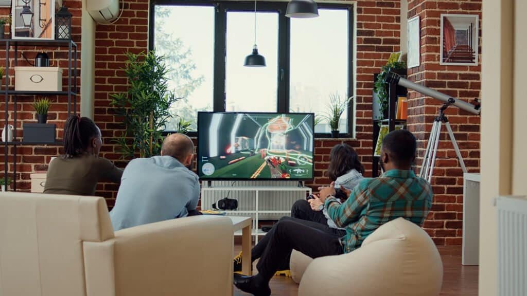 Four people playing video games in a living room.
